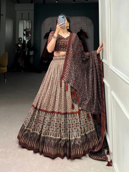 The timeless bandhani print chaniya choli showcases intricate ajrakh print and foil lacework, combining elegance and tradition in a stunning ensemble for Navratri